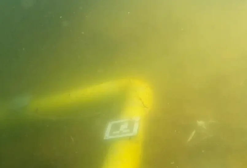 Photo showing our robosub inspecting a subsea pipeline underwater.